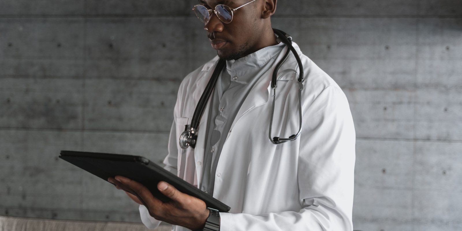 Doctor in white lab coat holding iPad