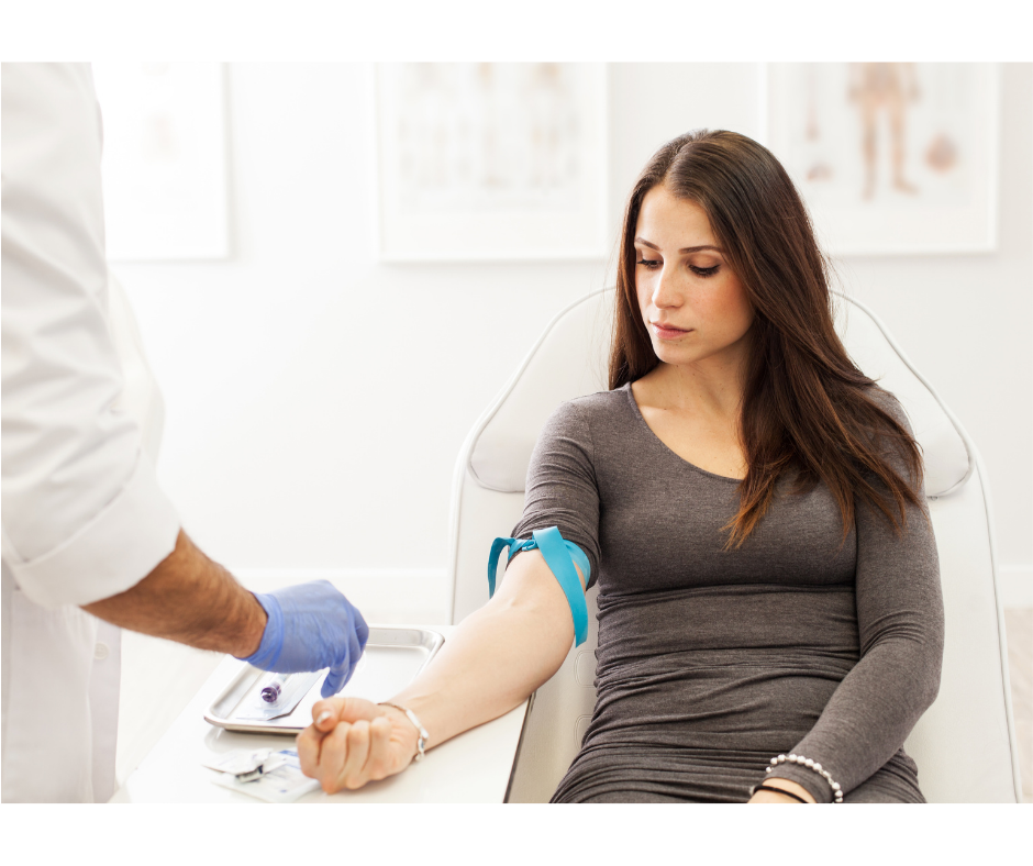 Woman getting blood drawn by phlebotomist 