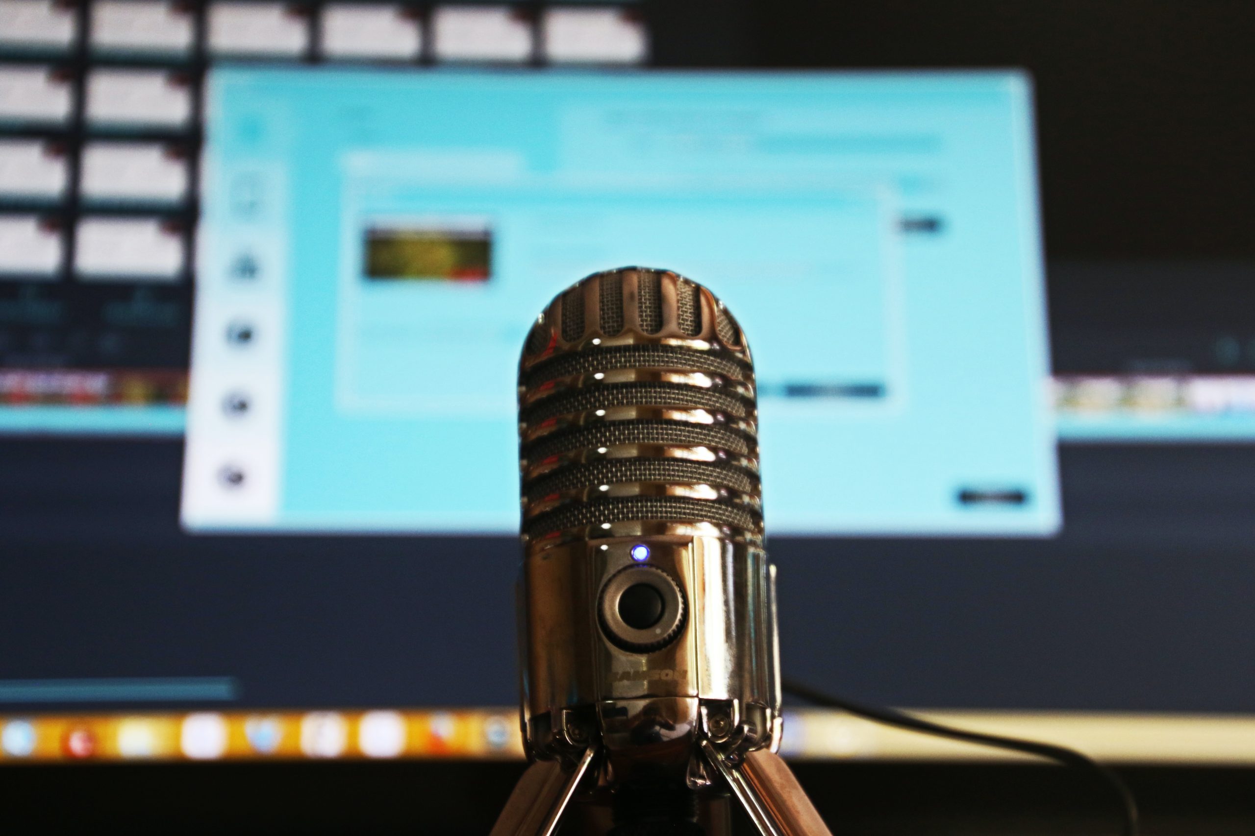 Podcast mic standing in front of laptop