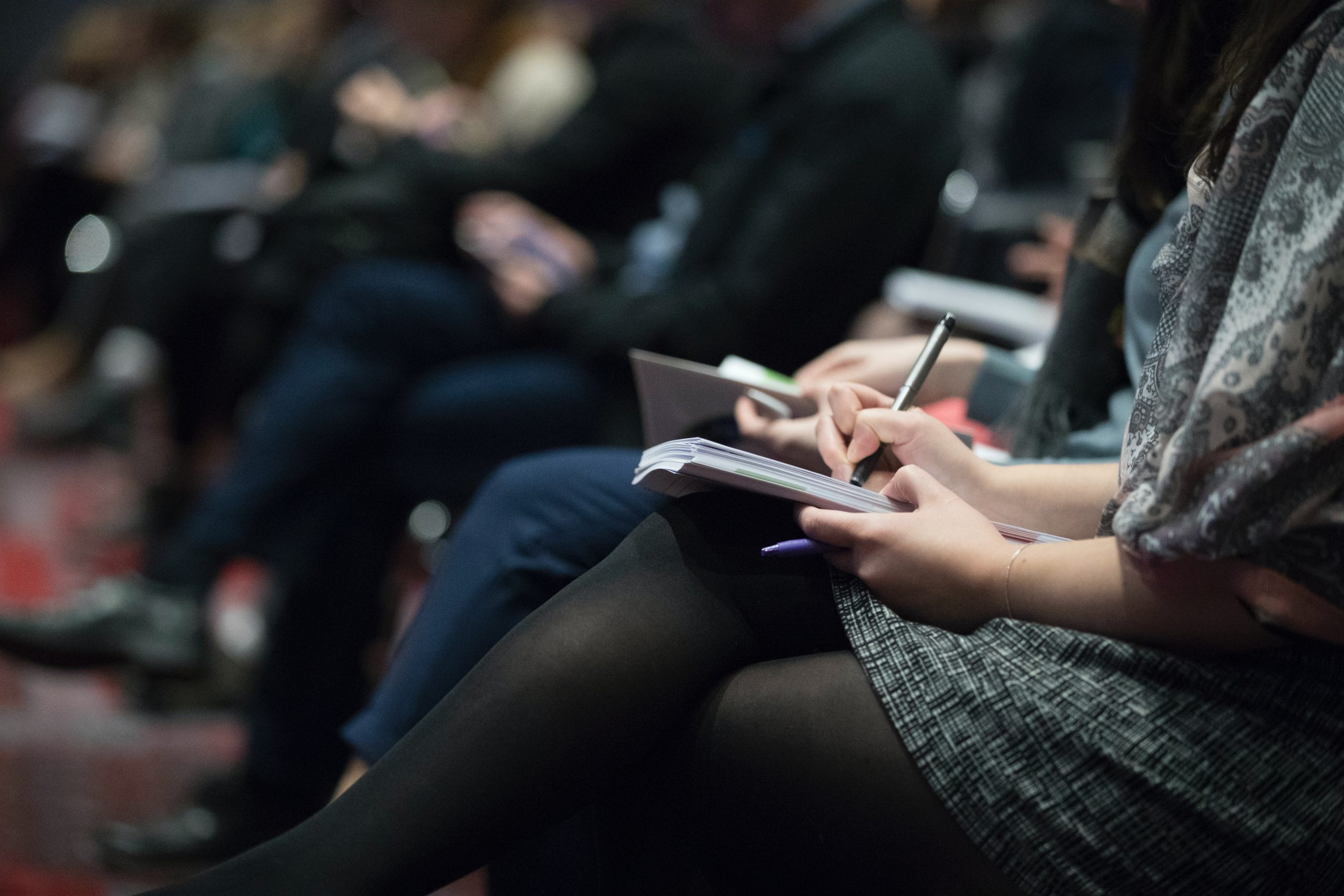 Woman taking notes in notebook at PSC conference