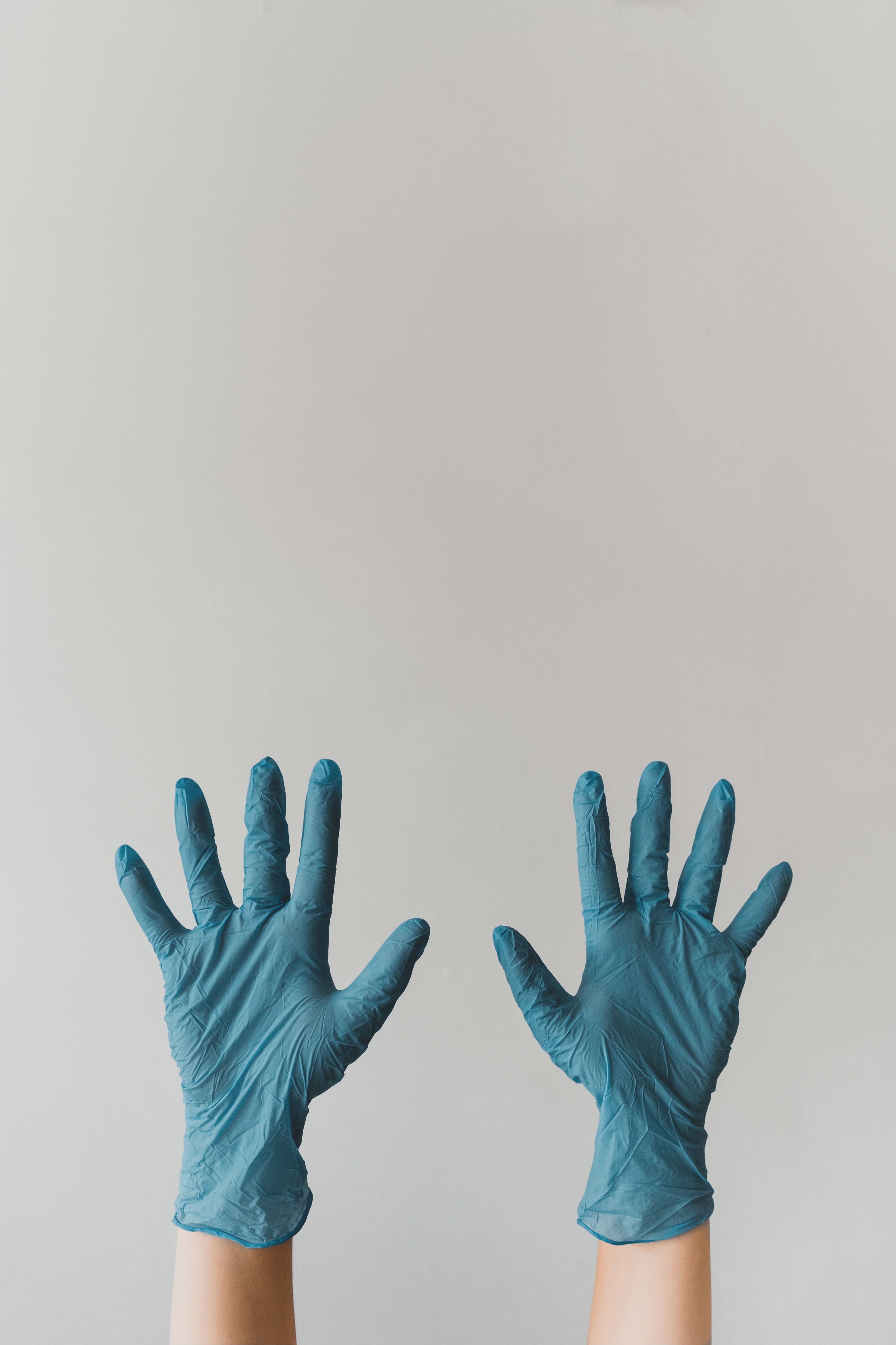 Two hands wearing blue latex gloves before liver ultrasound