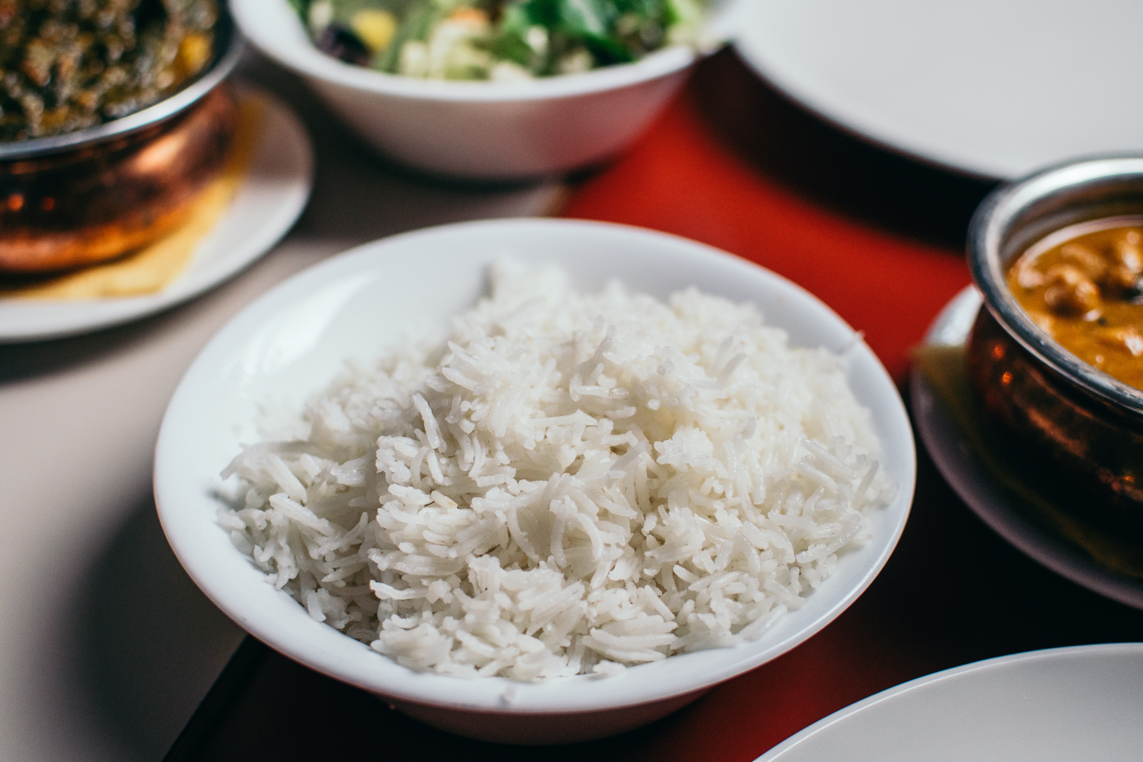 Bowl of white rice on a red tablecloth