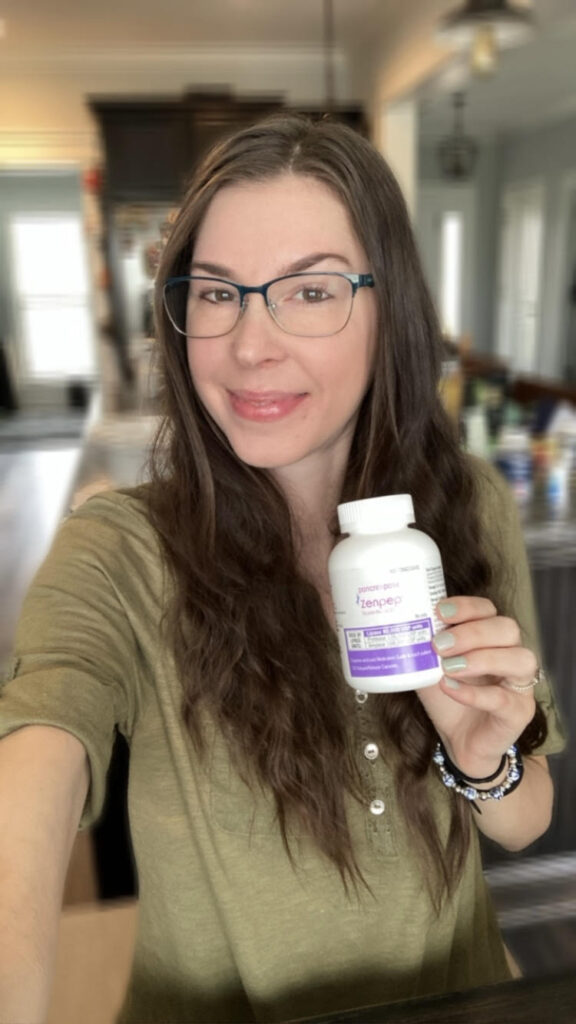 Jenna holding Zenpep digestive enzymes bottle